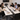Colleagues discussing documents and laptops around a Lurpes conference table in an office meeting