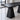 Charcoal black long rectangular table on two tapered block pedestals, visible surface detail in the same office