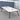 White rounded rectangular meeting table with a black edge, splayed black legs and two cable ports in the same office, closer product view