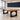Thick light-brown wood rectangular table with two black slab supports, each with a circular cutout in the same office, closer product view
