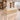 Champagne gold ribbed reception counter with white marble upper band in the same office, 45-degree view