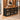 Oak and black diamond mesh reception counter in the same furnished warm office, 45-degree view
