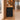Oak and black diamond mesh reception counter in the same furnished warm office, side view