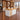 White and maple reception counter with three vertical wood strips in a furnished office, 45-degree view