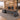 Walnut and charcoal executive desk with left storage return and slanted right support in a furnished office, 45-degree view