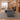 Walnut and charcoal executive desk with left storage return and slanted right support in a furnished office, side view