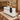 White marble reception counter with black draped accent in a furnished office, 45-degree view