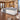 White and gray stone reception counter with raised right section in a furnished office, 45-degree view