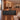 Walnut and charcoal L-shaped executive desk with LED front and file storage in a furnished office, side view