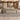 Gray wood and cream L-shaped executive desk with fluted front and side storage in a furnished office, front view