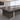 Dark wood conference table with pale central cable strip, framed plinths and two silver modesty-panel lines — detail of original visible surfaces in the same office