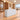 White reception counter with three horizontal panels in a furnished office lobby, 45-degree view