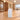 White reception counter with three horizontal panels in a furnished office lobby, side view