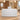 White reception counter with three horizontal panels in a furnished office lobby, front view
