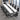 White and charcoal rectangular conference table with three loop supports and two cable ports in the same office, closer product view