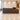 Walnut and charcoal reception counter in a functional hotel lobby, medium camera elevation