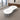 White double-rounded waisted meeting table with two cable ports and three silver supports in the office, full room view