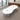 White double-rounded waisted meeting table with two cable ports and three silver supports in the same office, closer product view