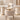 Slim ivory curved tabletop on two fluted cylindrical supports with gold base rings in the same office, closer product view