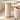 Slim ivory curved tabletop on two fluted cylindrical supports with gold base rings, visible surface detail in the same office