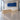 White and light oak straight reception desk in lobby - 45 degree view