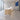 White and light oak straight reception desk in lobby - side view