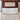 White curved reception desk with gold base in salon - front view