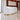 White curved reception desk with gold base in salon - 45 degree view