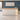 L-shaped cream and oak reception desk in office - front view